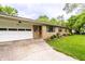Close up of charming single-story home with an attached garage and landscaping at 5450 Fenmore Rd, Indianapolis, IN 46228