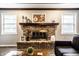Charming fireplace with brick surround, ideal for cozy evenings at home at 5450 Fenmore Rd, Indianapolis, IN 46228