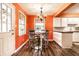 Bright eat-in kitchen with white cabinets, stainless steel appliances and modern light fixture at 5450 Fenmore Rd, Indianapolis, IN 46228