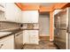 Spacious kitchen featuring white cabinets, stainless steel appliances, and dark countertops at 5450 Fenmore Rd, Indianapolis, IN 46228