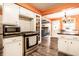 Updated kitchen with white cabinets, modern stainless steel appliances, and dark countertops at 5450 Fenmore Rd, Indianapolis, IN 46228