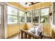 Cozy porch with a swing, surrounded by large windows offering serene outdoor views at 5450 Fenmore Rd, Indianapolis, IN 46228
