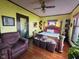 Comfortable bedroom with hardwood floors, a ceiling fan, and good natural lighting at 551 E 40Th St, Indianapolis, IN 46205