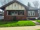 Charming craftsman-style home featuring a covered front porch and well-maintained lawn at 551 E 40Th St, Indianapolis, IN 46205