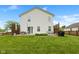 The back exterior features a two-story home with white siding, a patio, and a well-maintained yard, perfect for outdoor living at 5550 Sweet River Dr, Indianapolis, IN 46221