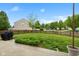 The backyard features a well-manicured lawn and a wooden fence surrounding the property, ensuring privacy at 5550 Sweet River Dr, Indianapolis, IN 46221