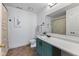 This is a full bathroom with a shower-tub combo, patterned shower curtain, and a vanity with a sage green cabinet at 5550 Sweet River Dr, Indianapolis, IN 46221