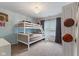 This bedroom features a bunkbed, basketball hoop, and basketball decor, all in a room with light blue walls at 5550 Sweet River Dr, Indianapolis, IN 46221