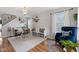 Bright dining area featuring hardwood floors, stylish lighting, and seating for up to six guests at 5550 Sweet River Dr, Indianapolis, IN 46221