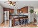 Modern kitchen with stainless steel appliances, dark cabinets, and center island with seating at 5550 Sweet River Dr, Indianapolis, IN 46221