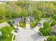An aerial view of the brick home situated on a cul-de-sac with mature trees at 5615 Burning Tree Ct, Indianapolis, IN 46239