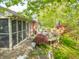 Enjoy outdoor living on this home's backyard deck with screened-in porch and mature trees providing shade at 5615 Burning Tree Ct, Indianapolis, IN 46239