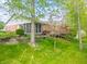 This backyard features a screened in porch, a deck and beautifully landscaped terraced yard at 5615 Burning Tree Ct, Indianapolis, IN 46239