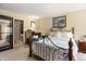 A charming bedroom with a floral bedspread, carpeted floors, and a closet with a mirror at 5615 Burning Tree Ct, Indianapolis, IN 46239