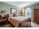 Comfortable bedroom with carpet flooring, complemented by natural light and a decorative headboard at 5615 Burning Tree Ct, Indianapolis, IN 46239