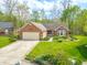 Charming brick ranch home featuring an attached two car garage and manicured lawn at 5615 Burning Tree Ct, Indianapolis, IN 46239