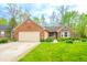 Charming brick home with attached garage and manicured lawn in a well-maintained community at 5615 Burning Tree Ct, Indianapolis, IN 46239