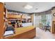 Spacious home office featuring custom built-ins, large desk, and natural light from the window at 5615 Burning Tree Ct, Indianapolis, IN 46239