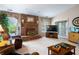 Neutral living room with brick fireplace, adjacent to the dining room with views to the exterior at 5615 Burning Tree Ct, Indianapolis, IN 46239