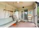 Relaxing screened-in porch with a swing, chair, and outdoor tools at 5615 Burning Tree Ct, Indianapolis, IN 46239