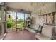 Inviting screened-in porch with a swing, table, and view of the backyard at 5615 Burning Tree Ct, Indianapolis, IN 46239