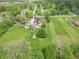 Aerial view showing the home's location in a peaceful neighborhood with expansive yards and mature trees at 5901 W Thompson Rd, Indianapolis, IN 46221