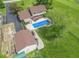 Aerial view showcasing the home's backyard pool, patio area, and detached garage with mature trees at 5901 W Thompson Rd, Indianapolis, IN 46221