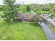 Expansive aerial view of the property, showcasing the home, lawn, and mature trees at 5901 W Thompson Rd, Indianapolis, IN 46221