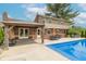 A stunning backyard featuring a sparkling pool and a charming covered patio with outdoor seating at 5901 W Thompson Rd, Indianapolis, IN 46221