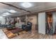Finished basement featuring durable wood-look floors, neutral paint, and ample recreational space at 5901 W Thompson Rd, Indianapolis, IN 46221