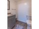 Well-maintained bathroom features vanity and toilet with luxury vinyl plank flooring at 5901 W Thompson Rd, Indianapolis, IN 46221