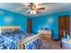 Cheerful bedroom with a ceiling fan, hardwood doors, and plenty of room for activities at 5901 W Thompson Rd, Indianapolis, IN 46221