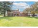 Beautiful two-story home with brick and vinyl siding, surrounded by lush landscaping and a spacious lawn at 5901 W Thompson Rd, Indianapolis, IN 46221