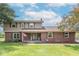 Charming two-story home with brick and vinyl siding, a well-manicured lawn, and an inviting covered porch at 5901 W Thompson Rd, Indianapolis, IN 46221