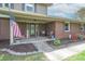 Inviting front porch with decorative seating and seasonal decor, plus a view of the landscaped front yard at 5901 W Thompson Rd, Indianapolis, IN 46221
