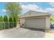 Detached garage with mature landscaping, a driveway, and a convenient pedestrian gate at 5901 W Thompson Rd, Indianapolis, IN 46221