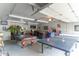 Recreation room in the garage including a pool table, ping pong table, and a bar at 5901 W Thompson Rd, Indianapolis, IN 46221