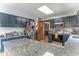 Modern kitchen with stainless steel appliances, granite countertops, and stylish navy blue cabinetry at 5901 W Thompson Rd, Indianapolis, IN 46221