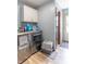 Functional laundry room with modern washer/dryer, ample storage, and easy access to the exterior at 5901 W Thompson Rd, Indianapolis, IN 46221