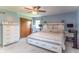 Bright main bedroom with a king-size bed, ceiling fan, and plenty of closet space at 5901 W Thompson Rd, Indianapolis, IN 46221