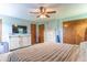 Inviting main bedroom featuring ample storage, a ceiling fan, and soft natural light at 5901 W Thompson Rd, Indianapolis, IN 46221