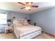 Serene main bedroom with a king-size bed, ceiling fan, and matching nightstands at 5901 W Thompson Rd, Indianapolis, IN 46221