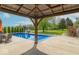 Captivating pool view from the covered patio, overlooking a lush backyard with a slide at 5901 W Thompson Rd, Indianapolis, IN 46221