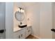 Modern bathroom featuring stylish black sink, round mirror, and white shiplap wall at 609 Delray Dr, Indianapolis, IN 46241