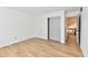 Spacious bedroom with hardwood floors, closet, and open doorway at 609 Delray Dr, Indianapolis, IN 46241