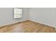 Bright bedroom with beautiful hardwood floors and natural light from the window at 609 Delray Dr, Indianapolis, IN 46241
