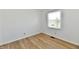 Well lit bedroom features a window offering a scenic view and beautiful hardwood floors at 609 Delray Dr, Indianapolis, IN 46241