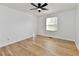 Bright bedroom showcasing hardwood floors, ceiling fan, and natural light from the window at 609 Delray Dr, Indianapolis, IN 46241