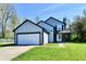 Charming two-story home with gray siding, black trim, and a two-car garage showcasing its curb appeal at 609 Delray Dr, Indianapolis, IN 46241