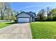 Charming two-story home with gray siding, black trim, and a two-car garage showcasing its curb appeal at 609 Delray Dr, Indianapolis, IN 46241